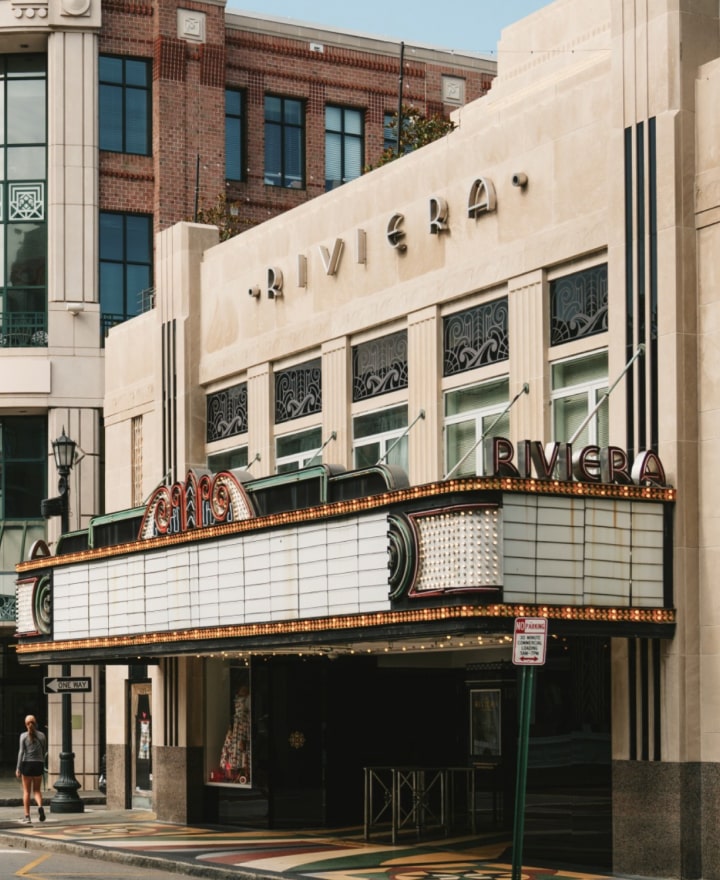 Front-facing view of the Riviera Theater entrance with signage visible.