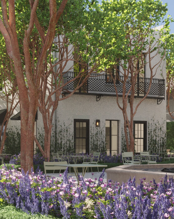 this image depicts a building with outdoor space and tables with chairs + flowers