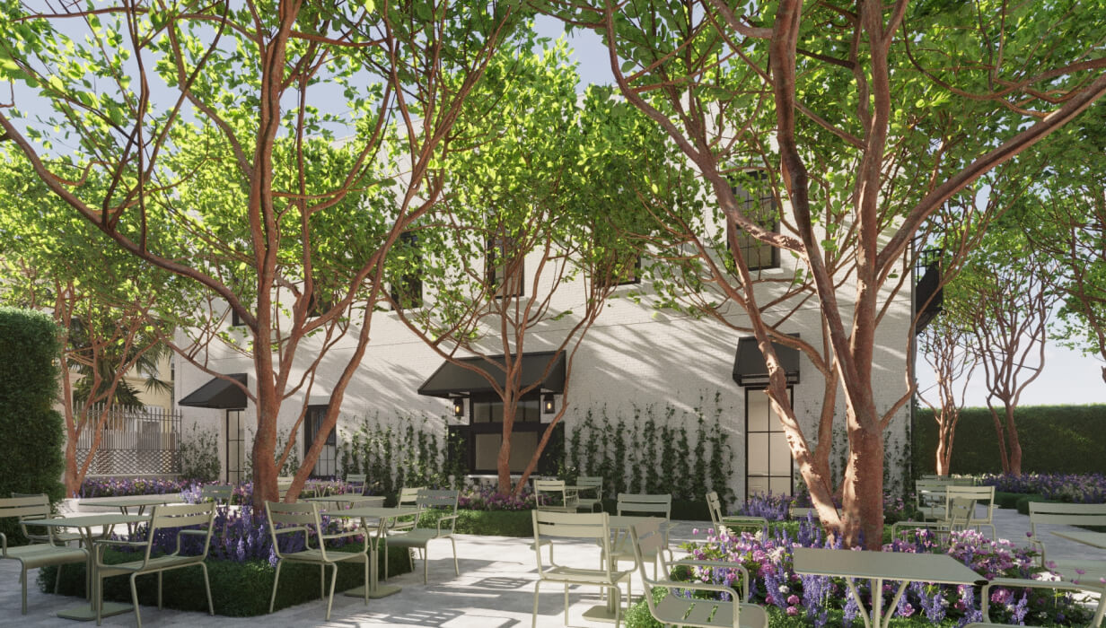 this image depicts a building with outdoor space and tables with chairs + flowers