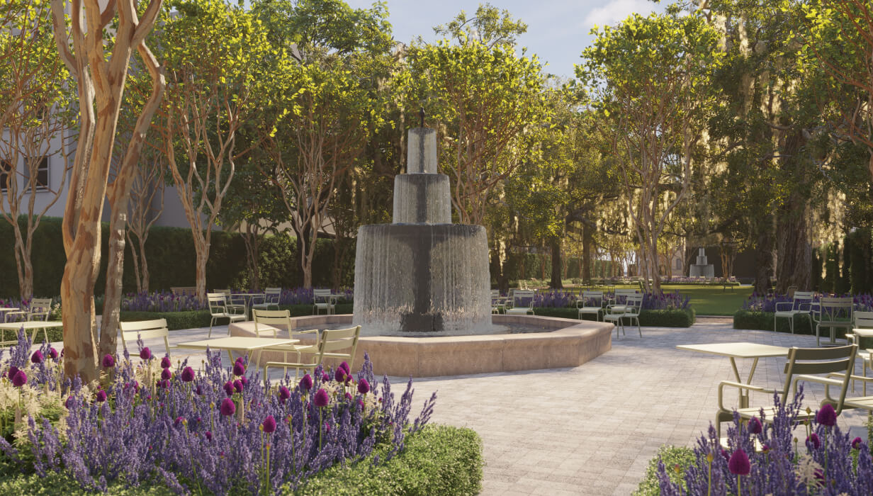 This image depicts tables and chairs with purple flowers outside and a fountain