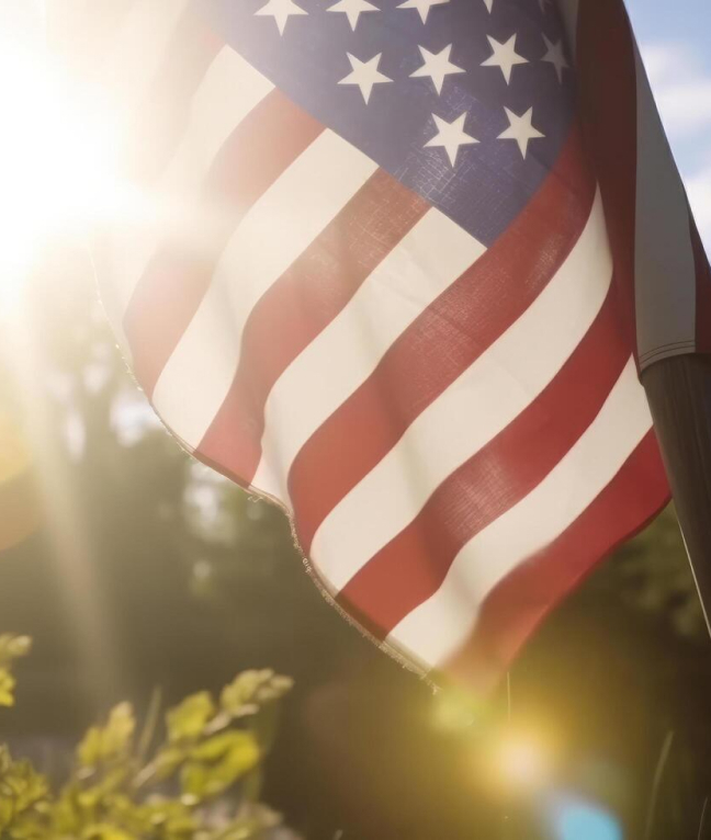 This image depicts an American flag with sunlight behind it