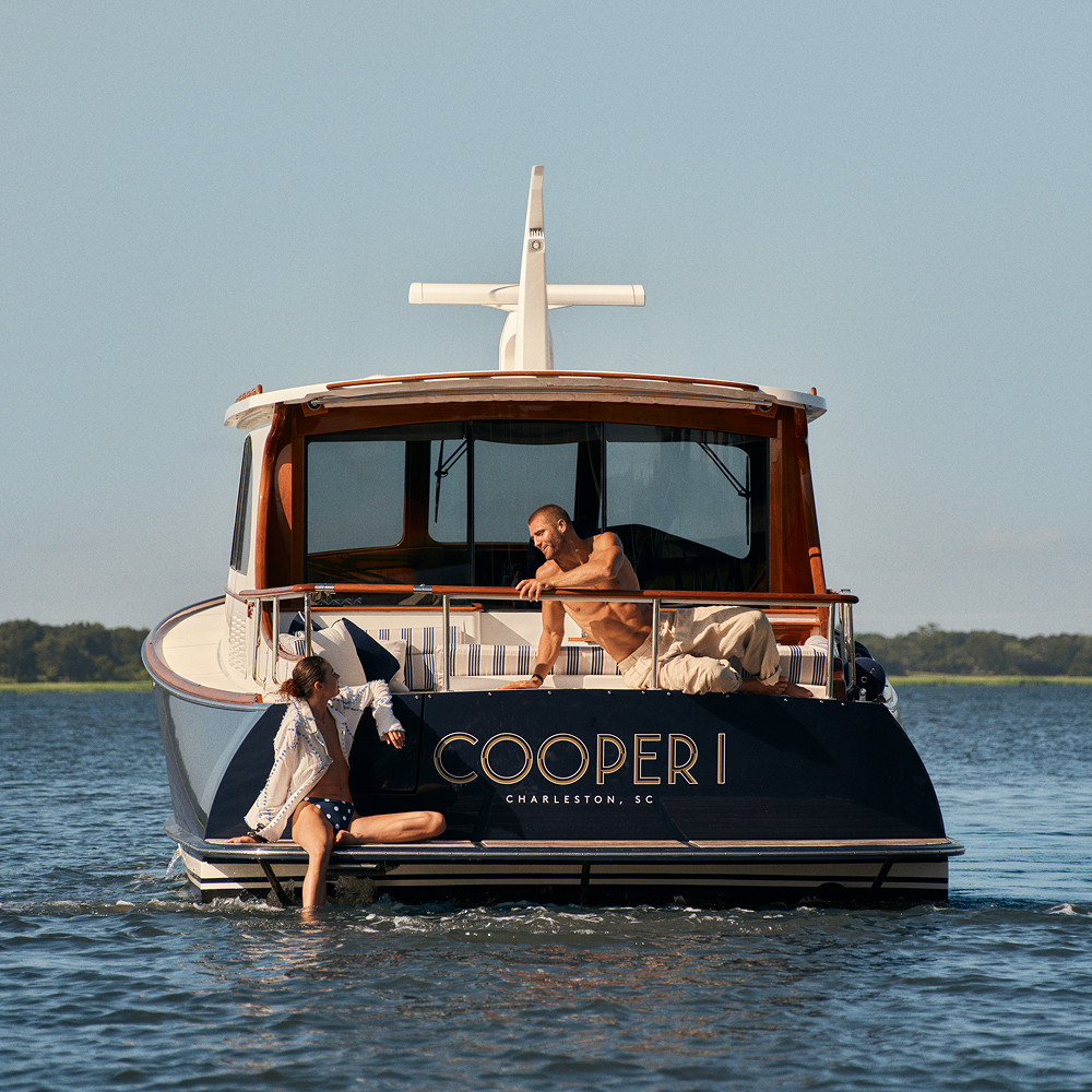 this image depicts a couple on a boat in the water looking at one another