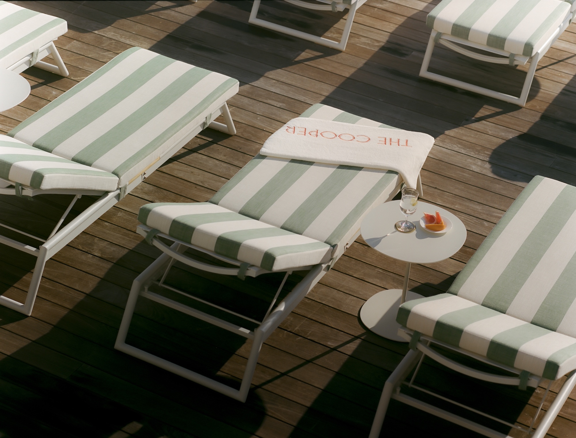 Photo of pool lounger with branded The Cooper towel